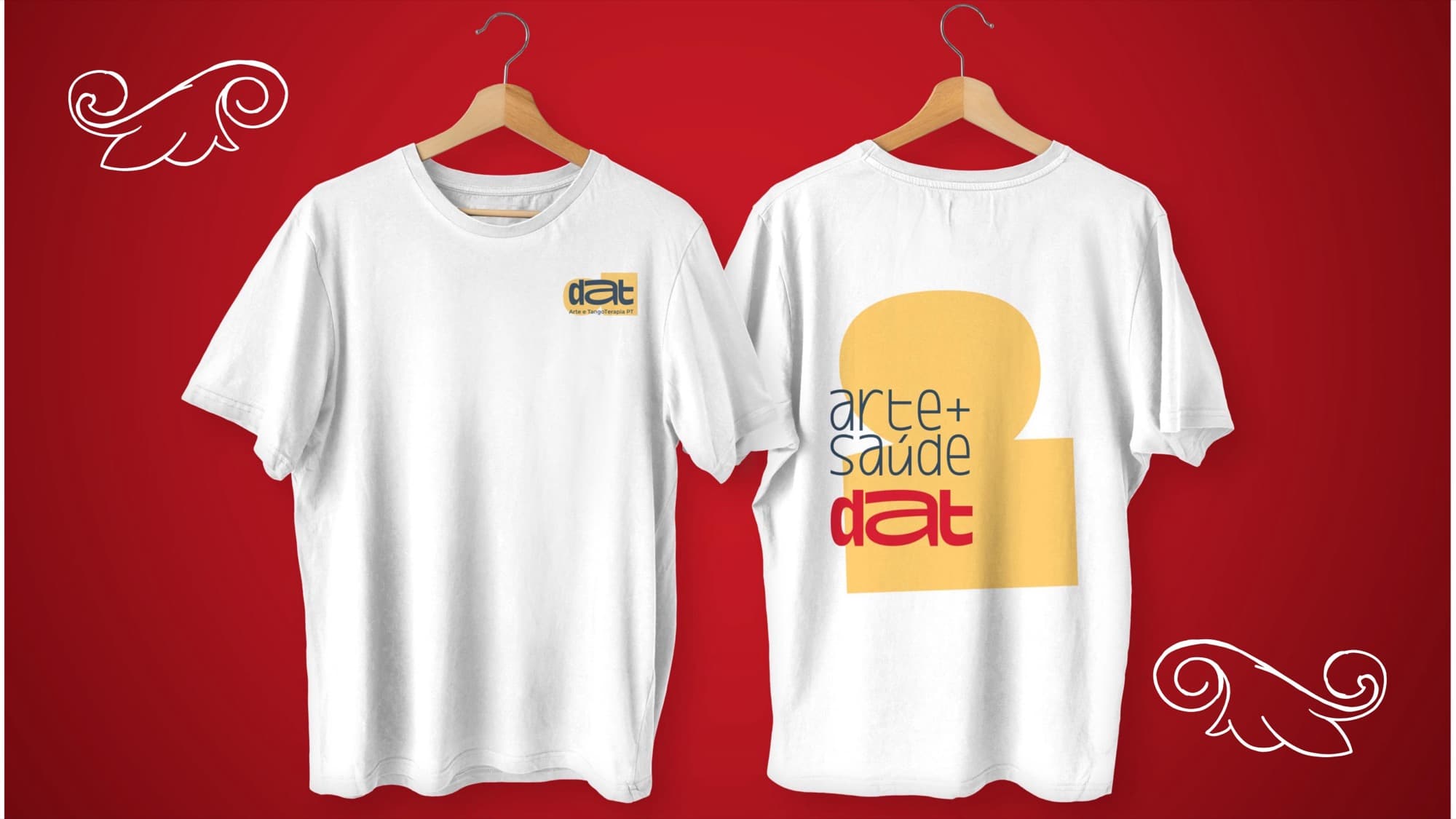 A white t-shirt on hangers, front and back: a small logo on the chest and "arte + saúde dat" large on the back.